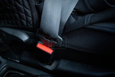 Photo for Fastened seat belt in a black car, close-up. Driver use the safety seat belt before drive a car. - Royalty Free Image