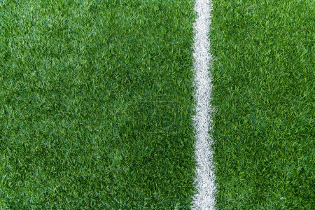 Photo for Vertical white stripe markings on the green grass of the football field. - Royalty Free Image
