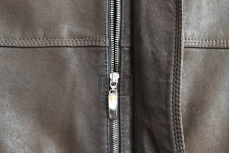 Photo for Metal zipper with lock. The zipper is sewn into the leather jacket. - Royalty Free Image
