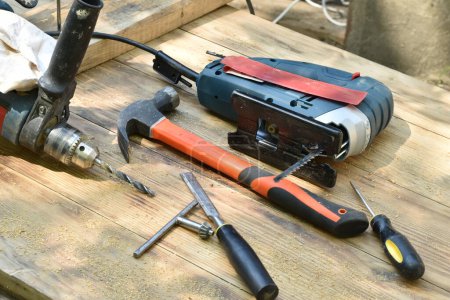 Photo for Workshop scene. Tools on the table, jigsaw, hammer, screwdriver and drill. High quality photo - Royalty Free Image