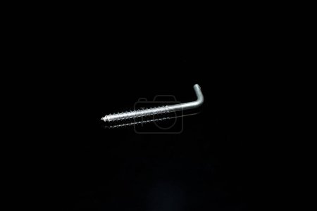 Photo for A screw made of steel with a hook on a black background. - Royalty Free Image
