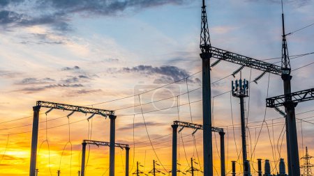 Photo for Production of fuel and electricity.Electrical networks with wires and transformers at sunset.Power transmission lines and from the power plant.Power lines with wires under voltage and electric current - Royalty Free Image