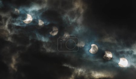 Téléchargez les photos : Solar eclipse on the cloudy background. Eclipse of the sun at the cloudy weather. In Kryviy Rih, Ukraine. - en image libre de droit