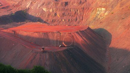 Téléchargez les photos : Bulldozers and trucks in quarry with red ground. Mining iron ore in Kriviy Rih, Ukraine. Industrial landscape - en image libre de droit