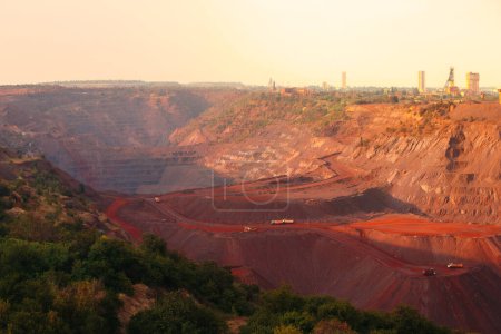 Téléchargez les photos : Bulldozers and trucks in quarry with red ground. Mining iron ore in Kriviy Rih, Ukraine. Industrial landscape - en image libre de droit