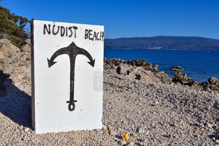 Photo for A nudist beach on a deserted rocky shore of the Adriatic Sea with a beautiful view of the neighboring shore. A specially drawn sign indicates a meeting place for like-minded people - Royalty Free Image
