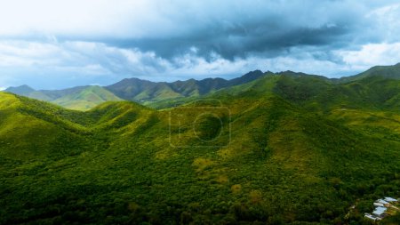 Landscape with clouds in the summer. Green mountings with wide angle shot. Dark blue clouds in the mountings.