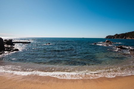 Beautiful seascape on the quiet waters of Mediterranean Sea shore in a beautiful beach in Costa Brava, Catalonia