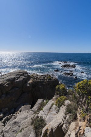 Quiet waves on rock cliffs in a beautiful seascape in Costa Brava, Catalonia, Mediterranean Sea