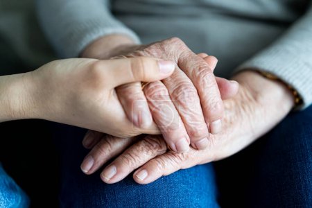 Photo for Young hand holding old hands of a woman. Soft focus. Supporting in old age concept - Royalty Free Image