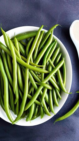 fresh green beans on a black background