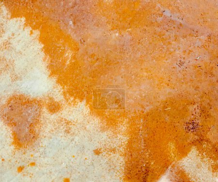 Photo for A photography of a dirty surface with a brown substance, there is a close up of a piece of pizza with a lot of sauce. - Royalty Free Image
