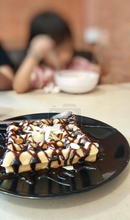 Photo for A photography of a plate of food with a chocolate drizzle on it, there is a plate of food with a chocolate sauce drizzle on it. - Royalty Free Image