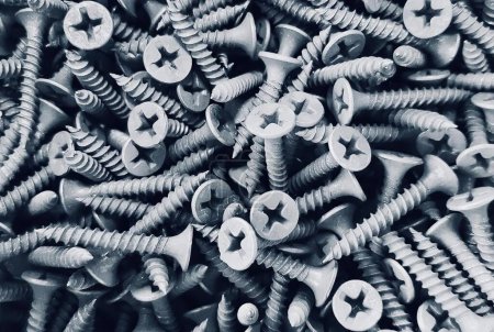 Photo for A photography of a pile of screws and bolts in black and white, a close up of a pile of screws and nails on a table. - Royalty Free Image