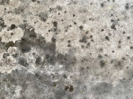 Photo for A photography of a dirty concrete wall with a bunch of small holes, concrete wall with a lot of black spots and a yellow fire hydrant. - Royalty Free Image