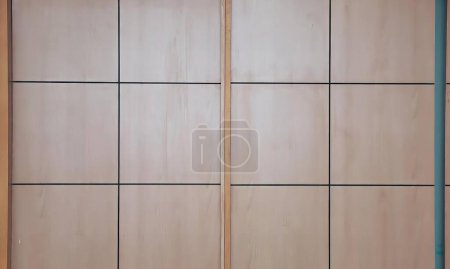 Photo for A photography of a bathroom with a toilet and a wooden door, sliding door with a blue handle and a white toilet. - Royalty Free Image