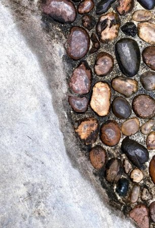 Photo for A photography of a stone walkway with rocks and gravel on it, spirally shaped stones and gravel on a sidewalk in a city. - Royalty Free Image