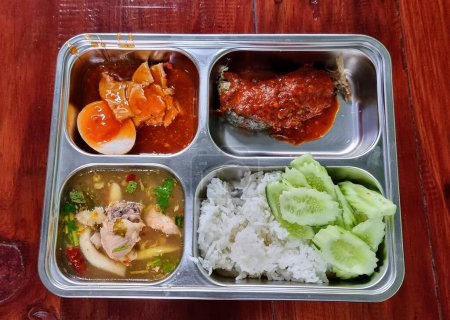 a photography of a metal tray with a variety of food items.