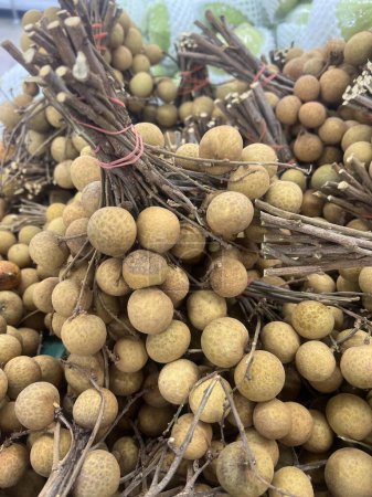 a photography of a pile of longan fruit sitting on top of a table.