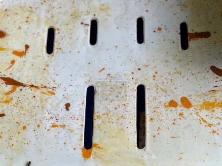 a photography of a dirty pan with a knife and some sauce.