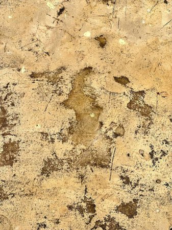 a photography of a dirty wall with a small hole in it.