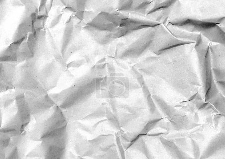 a photography of a piece of crumpled paper with a black and white photo.