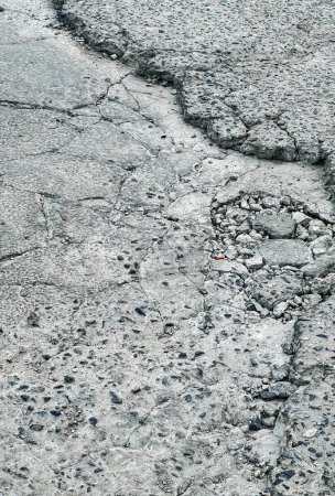 a photography of a crack in the road with a fire hydrant.