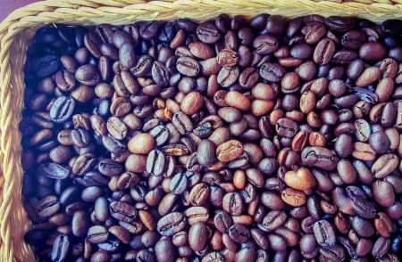 a photography of a basket filled with coffee beans on top of a table.