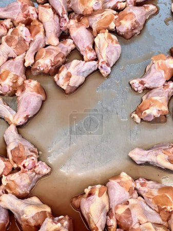 a photography of a pan filled with chicken wings and sauce.