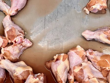 Photo for A photography of a bunch of raw chicken in a pan. - Royalty Free Image