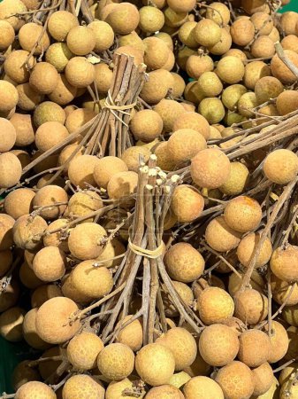 a photography of a bunch of longan fruit sitting on top of a table.