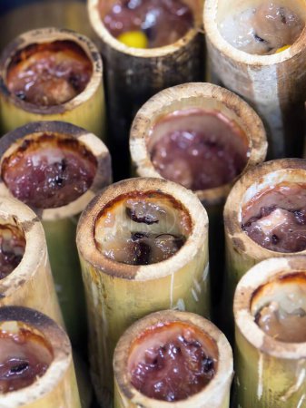 a photography of a bunch of bamboo sticks with a lot of food inside.