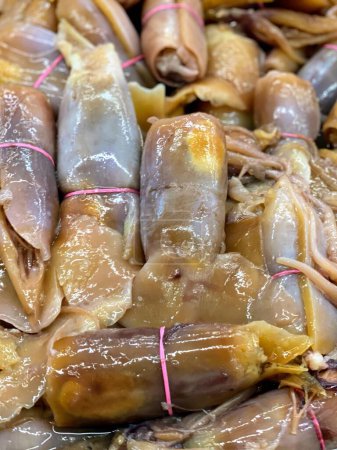 a photography of a pile of cooked fish wrapped in plastic.