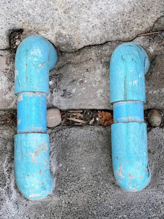 Photo for A photography of a blue pipe on the ground next to a wall. - Royalty Free Image