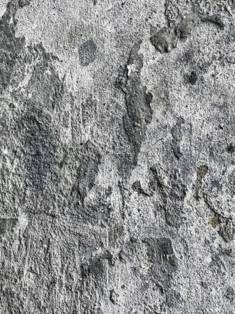 a photography of a close up of a cement wall with a black and white photo.