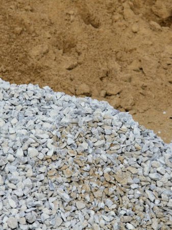a photography of a pile of gravel and gravel next to a pile of dirt.
