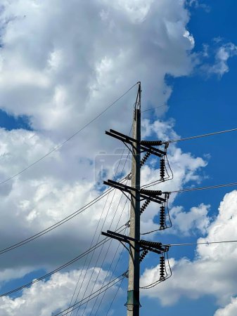 a photography of a power pole with a sky background.