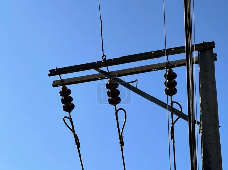 a photography of a power pole with a bunch of wires.