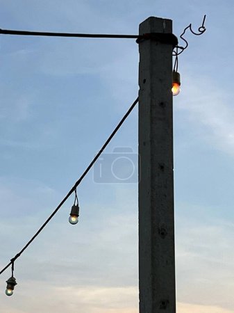 Téléchargez les photos : Une photographie d'un poteau avec un tas de lumières suspendues à lui. - en image libre de droit