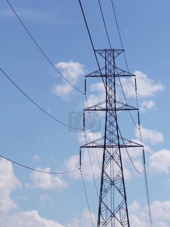 a photography of a large power line with a sky background.