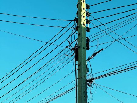 Photo for A photography of a telephone pole with many wires and a blue sky. - Royalty Free Image