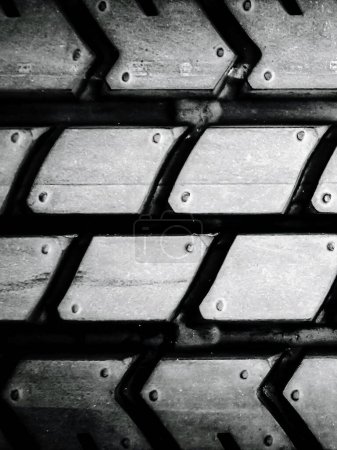 a photography of a tire tread with rivets on it.