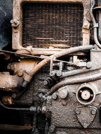 a photography of a close up of a dirty engine on a train.