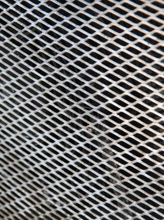 a photography of a close up of a metal grill grate.