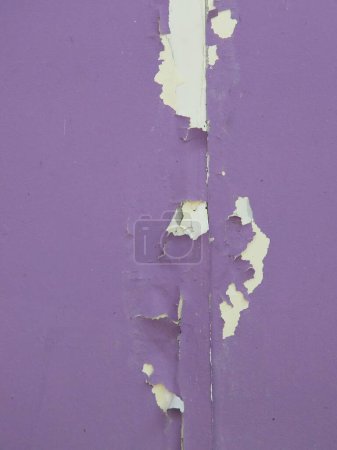 a photography of a purple wall with peeling paint and a white paint line.