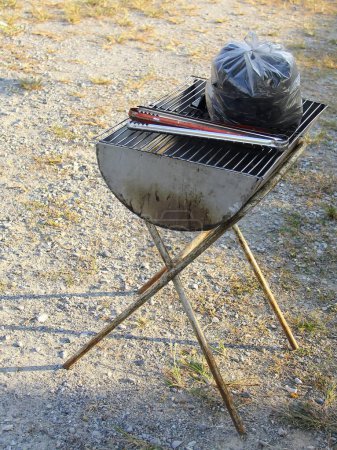 a photography of a grill with a bag of food on top of it.