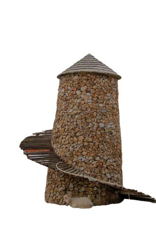 Foto de Una fotografía de una casa de pájaros hecha de rocas y un comedero de aves. - Imagen libre de derechos
