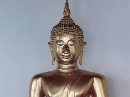 a photography of a statue of a buddha sitting on a table.