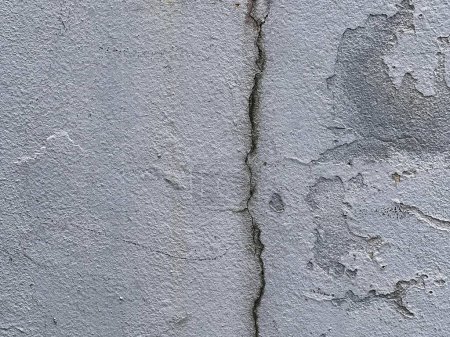 una fotografía de una grieta en el muro de hormigón de un edificio.