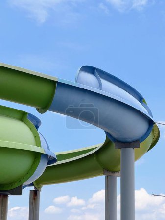 Photo for A photography of a water slide going down a hill with a blue sky in the background. - Royalty Free Image
